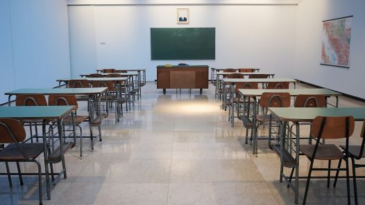 empty classroom with desks and a chalkboard