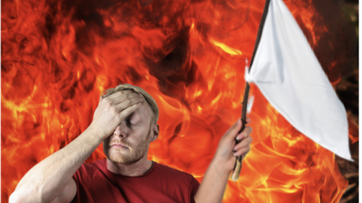 man holding a white flag against a fiery background